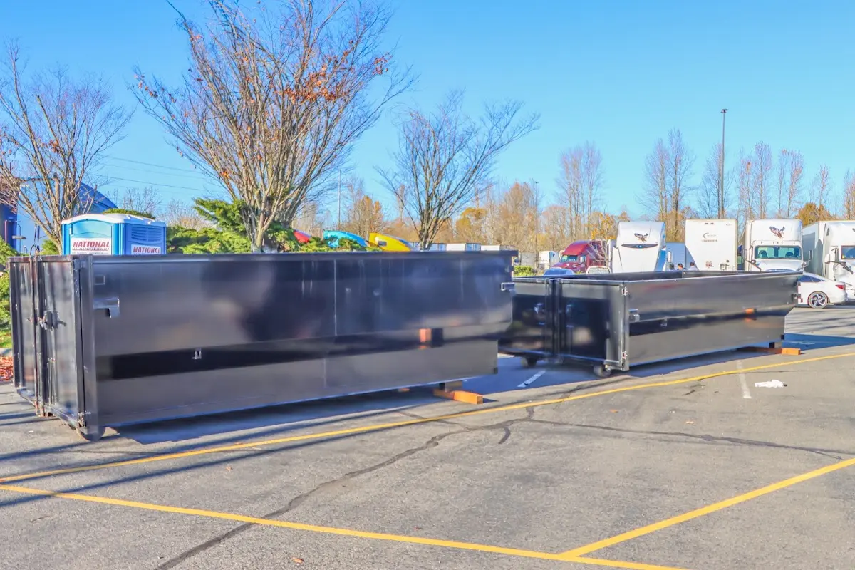 Professional dumpster rental service with roll-off container on residential driveway in North Weeki Wachee